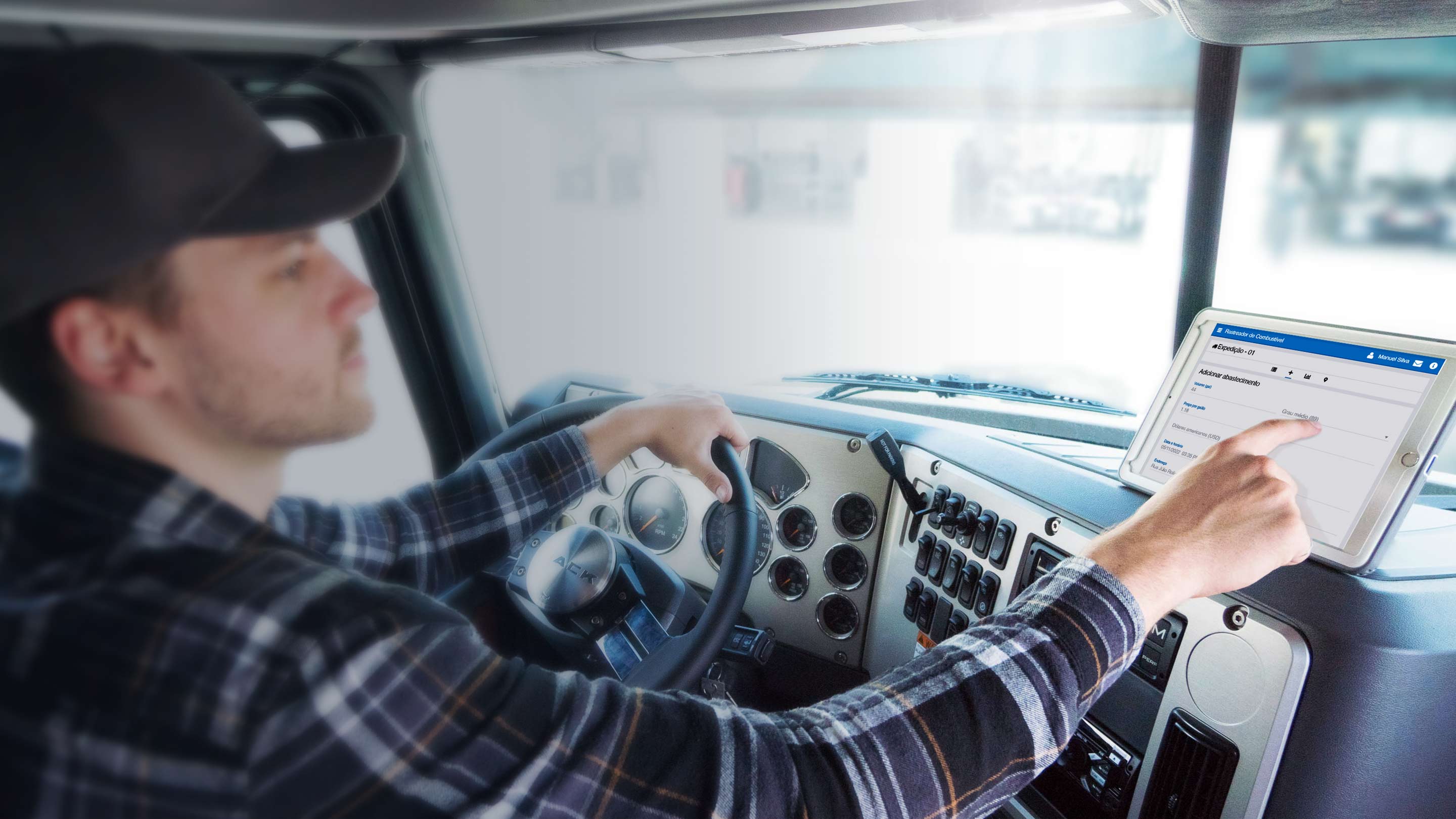 Motorista dentro de um caminhão utilizando um tablet para registrar abastecimento no aplicativo Fuel Tracker. A tecnologia da Geotab auxilia no monitoramento de frota e na gestão de combustível da frota, garantindo mais eficiência e controle operacional.